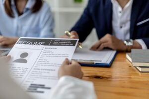 atmosphere-interview-room-start-up-company-applicant-is-handing-resume-interviewer-as-supporting-document-interview-two-interviewers-job-interview-concept_528263-722